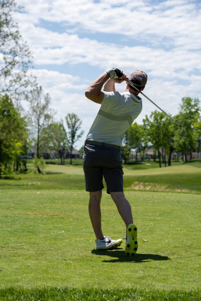 Club Golfer hitting golf ball